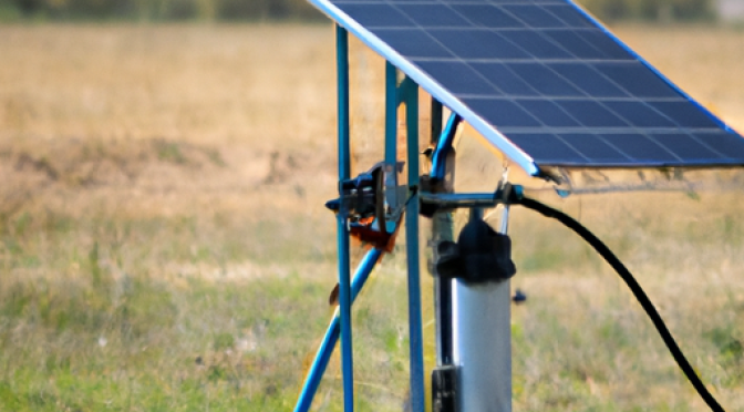 Water pump powered by solar panels in a field, photo