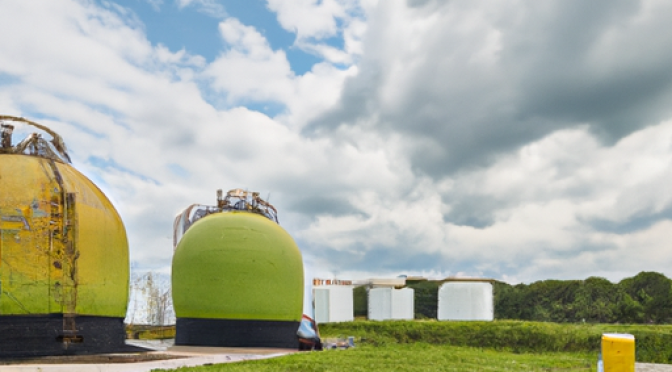 Image of a biogas production facility with gas tanks.