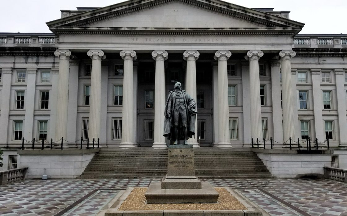 Bronze statue of Albert Gallatin in front of the columned facade of the US Treasury Building