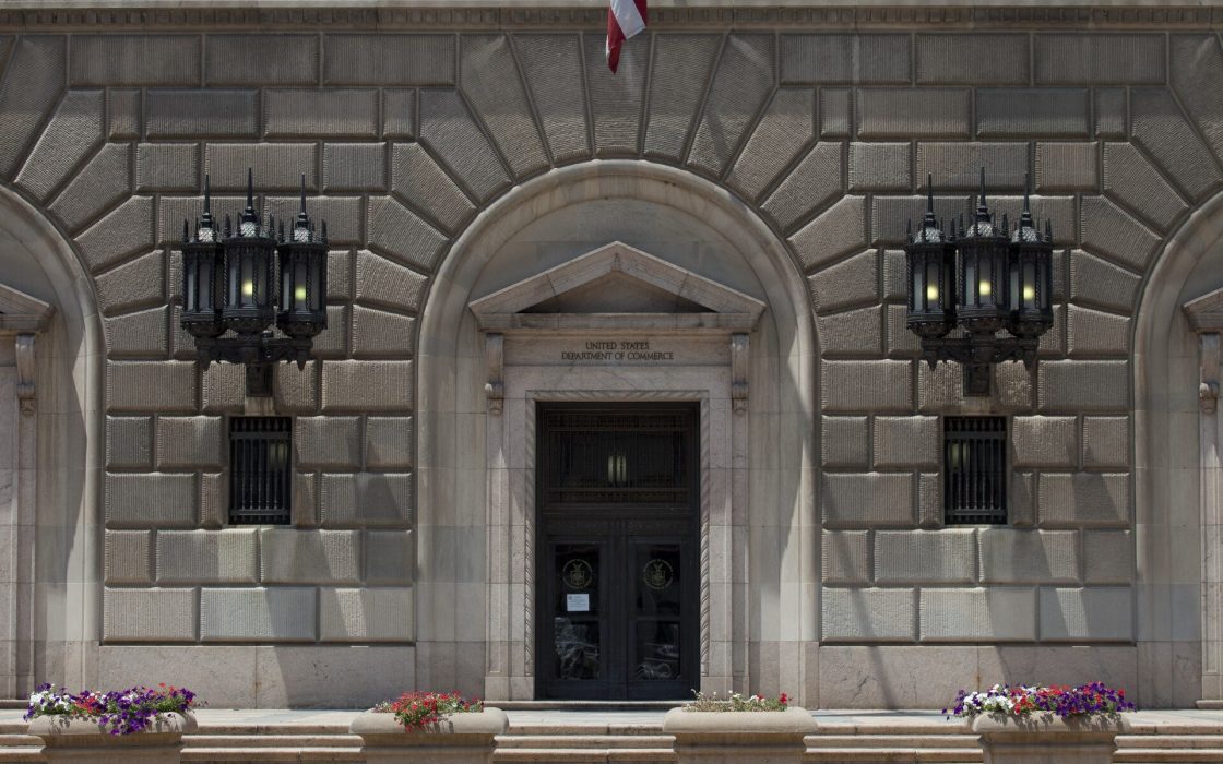 Stone facade and arched entrance of the U.S. Department of Commerce building