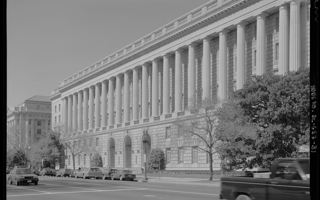 Black-and-white photo of the colonnaded IRS headquarters building along Constitution Avenue