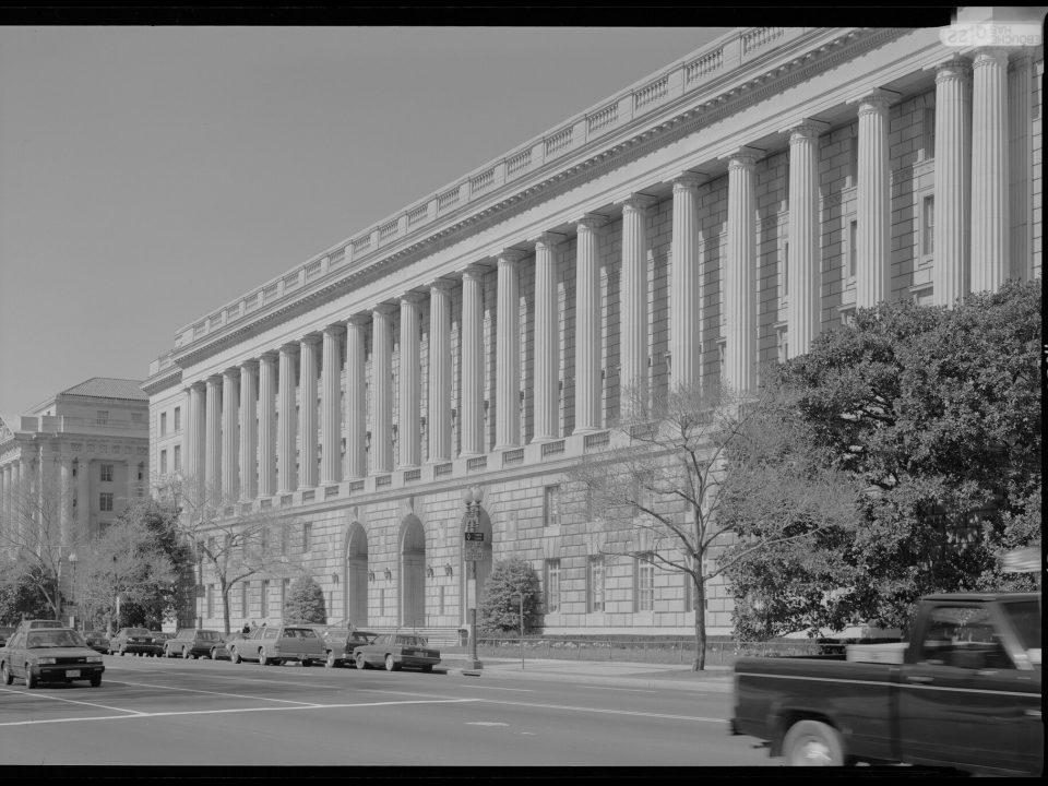 Black-and-white photo of the colonnaded IRS headquarters building along Constitution Avenue