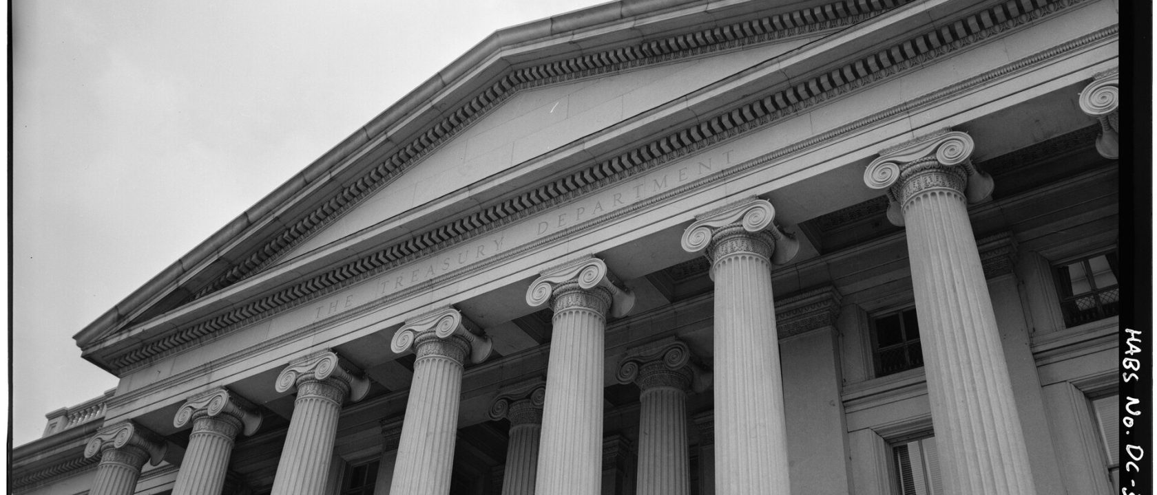Black-and-white view of the Treasury building's columned portico and pediment