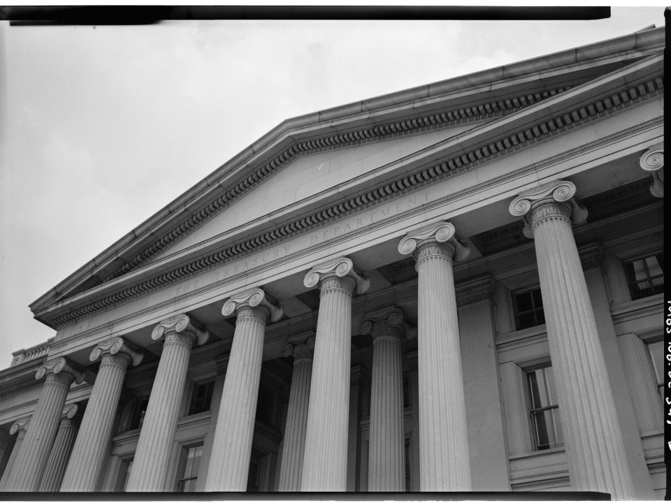 Black-and-white view of the Treasury building's columned portico and pediment